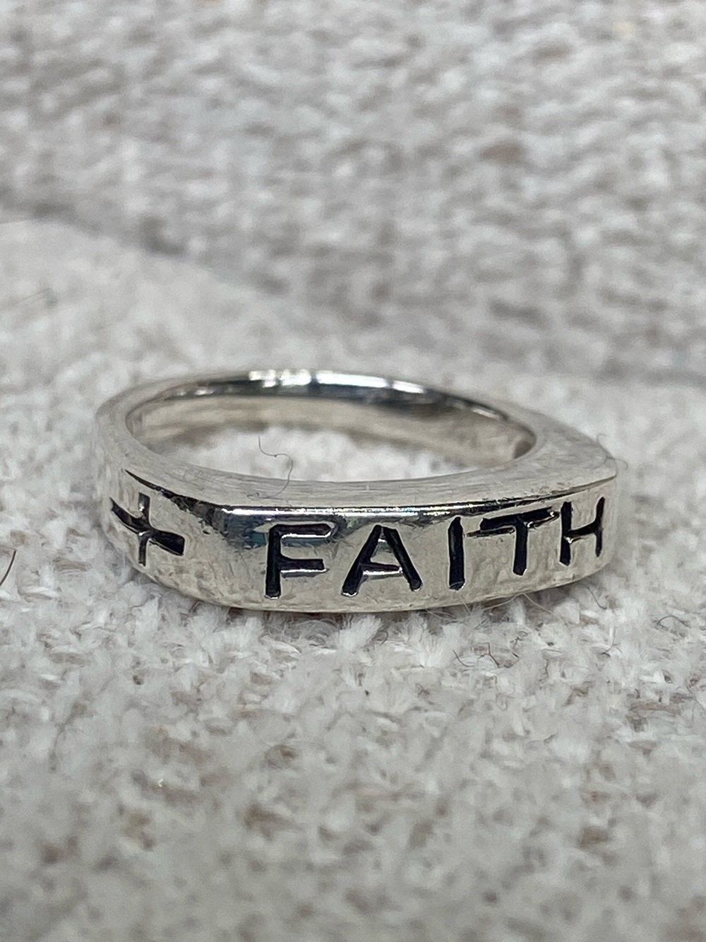 Sterling Silver band inscribed with "FAITH" and a cross on each side. Size 5